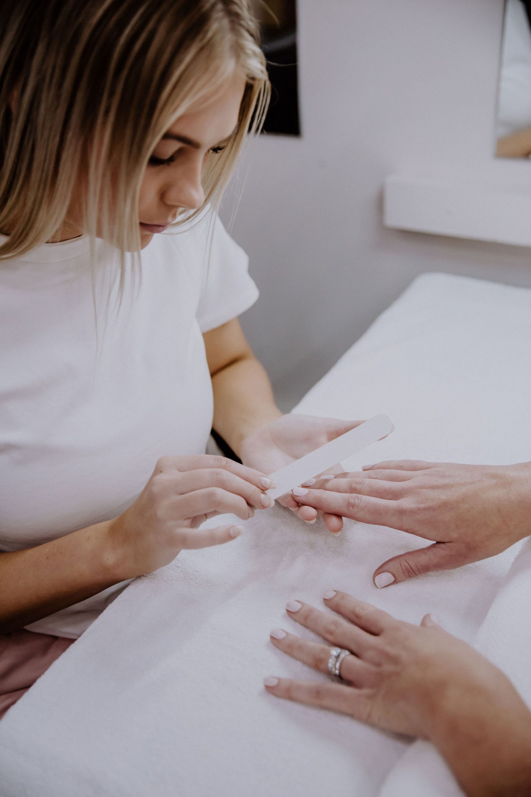 Staff member with a client during a Nail Appointment