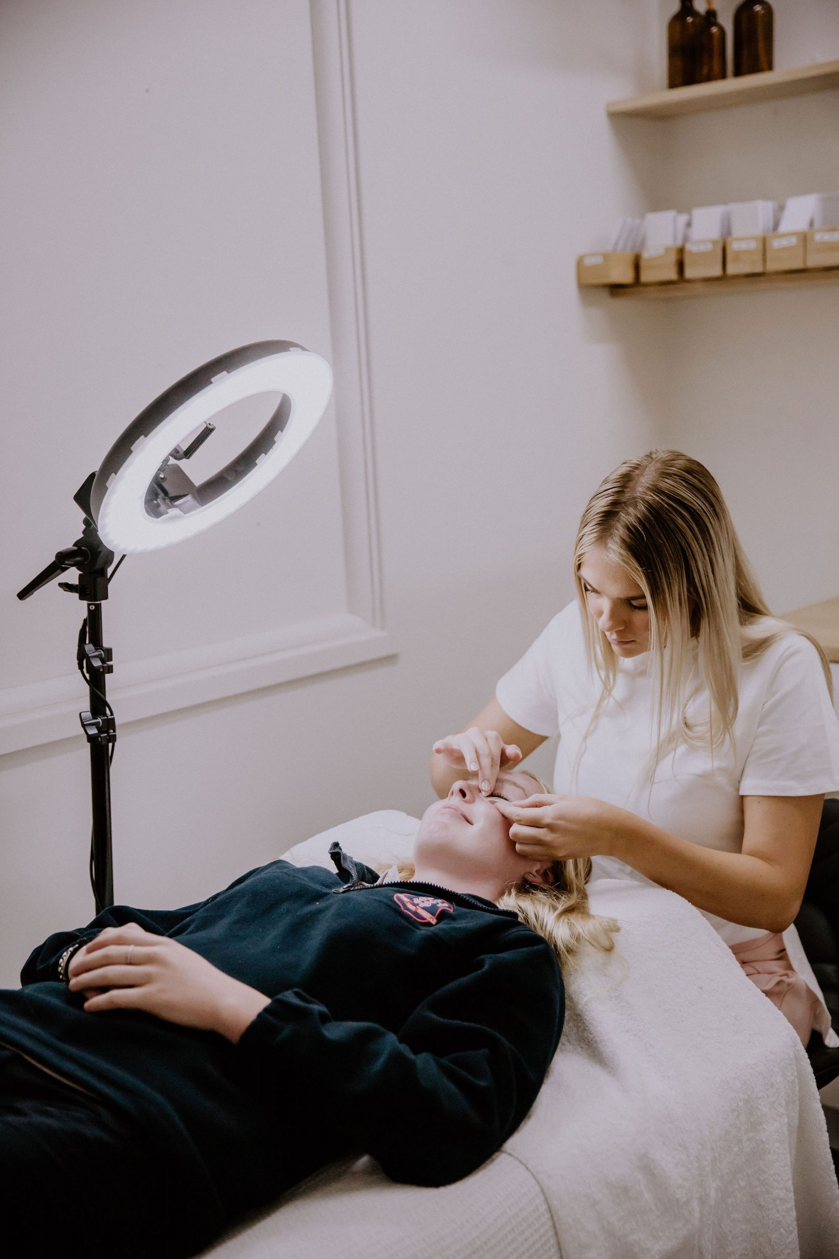 Staff member with a client during a lash session