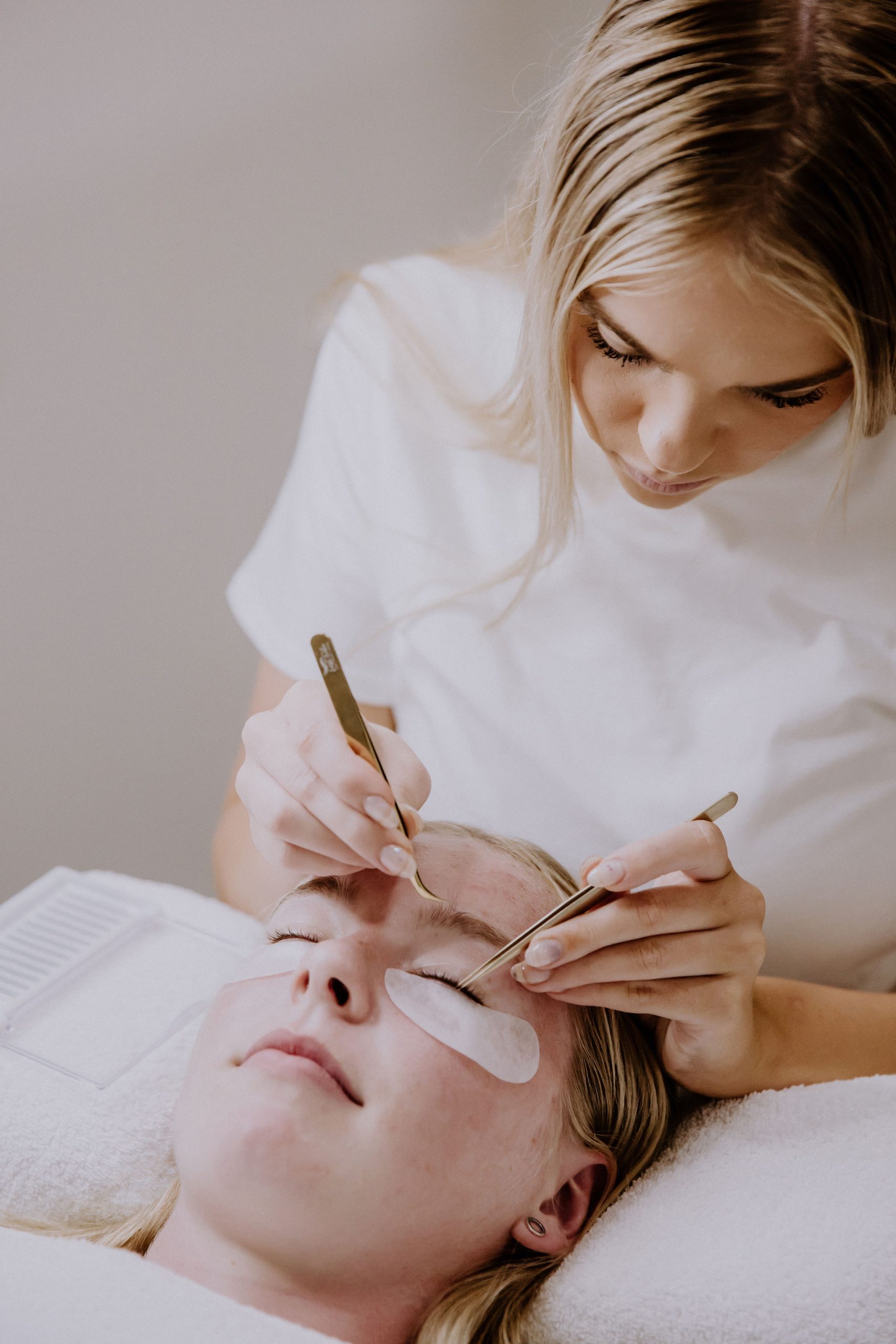 Staff member with a client during a lash session