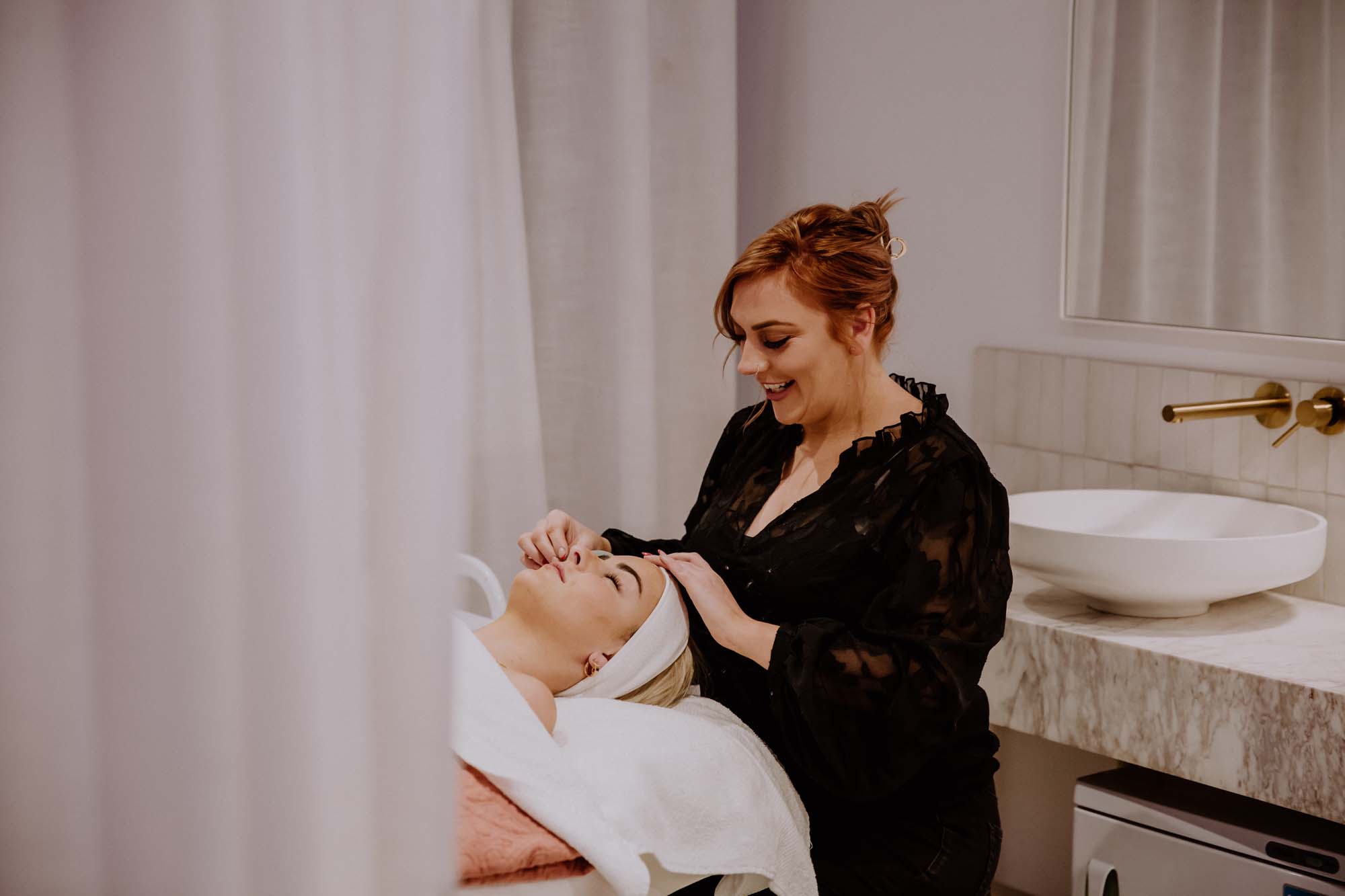 Krystal applying a Masque to a client's face